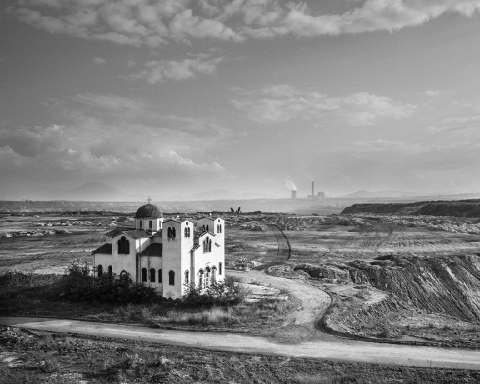 A church is what remains of the village of Komanos, destroyed by the expanding coal mine of Ptolemaida. Greece, 2014