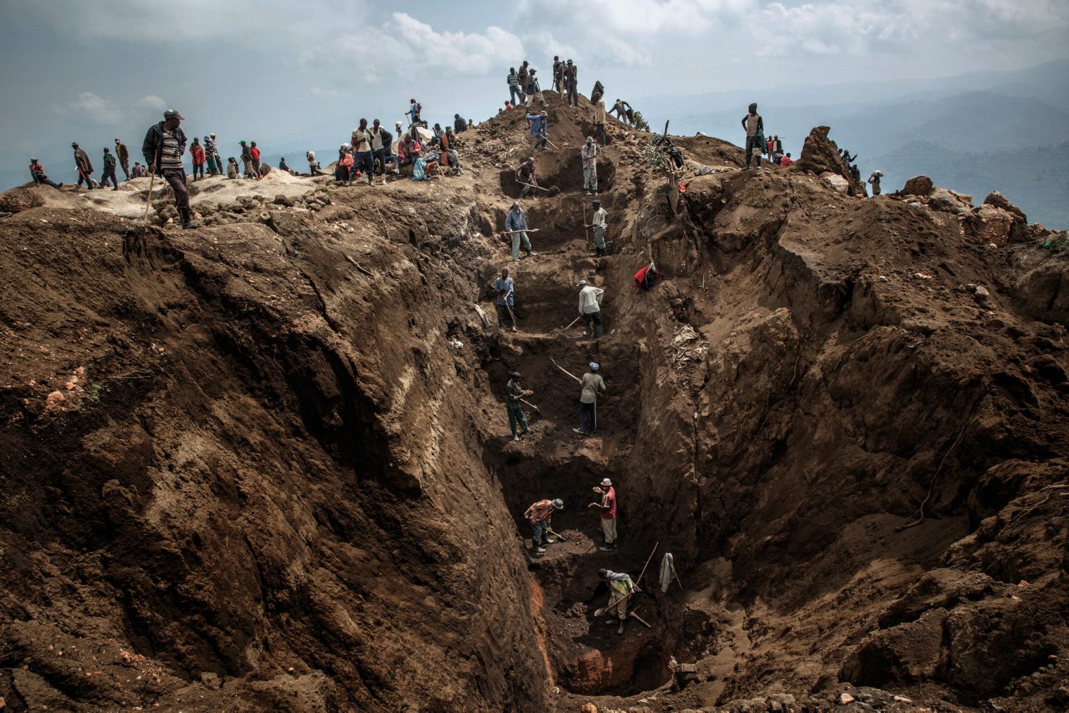 Workers exiting a mine shaft. Miners dig 50 meters underground for the minerals before transporting them to a nearby river where they are separated from rocks and sand before being sold to dealers. Mine accidents are common.  Rubaya, Republic Democratic of Congo, 2013