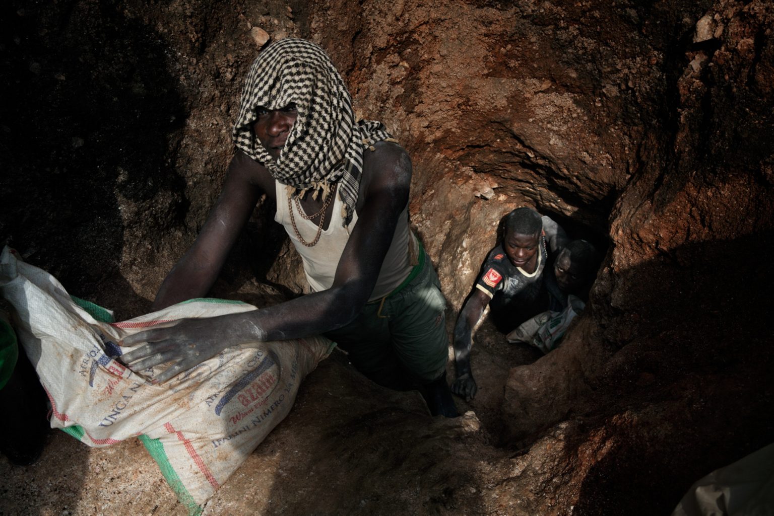 Workers exiting a mine shaft. Miners dig 50 meters underground for the minerals before transporting them to a nearby river where they are separated from rocks and sand before being sold to dealers. Mine accidents are common.  Rubaya, Republic Democratic of Congo, 2013