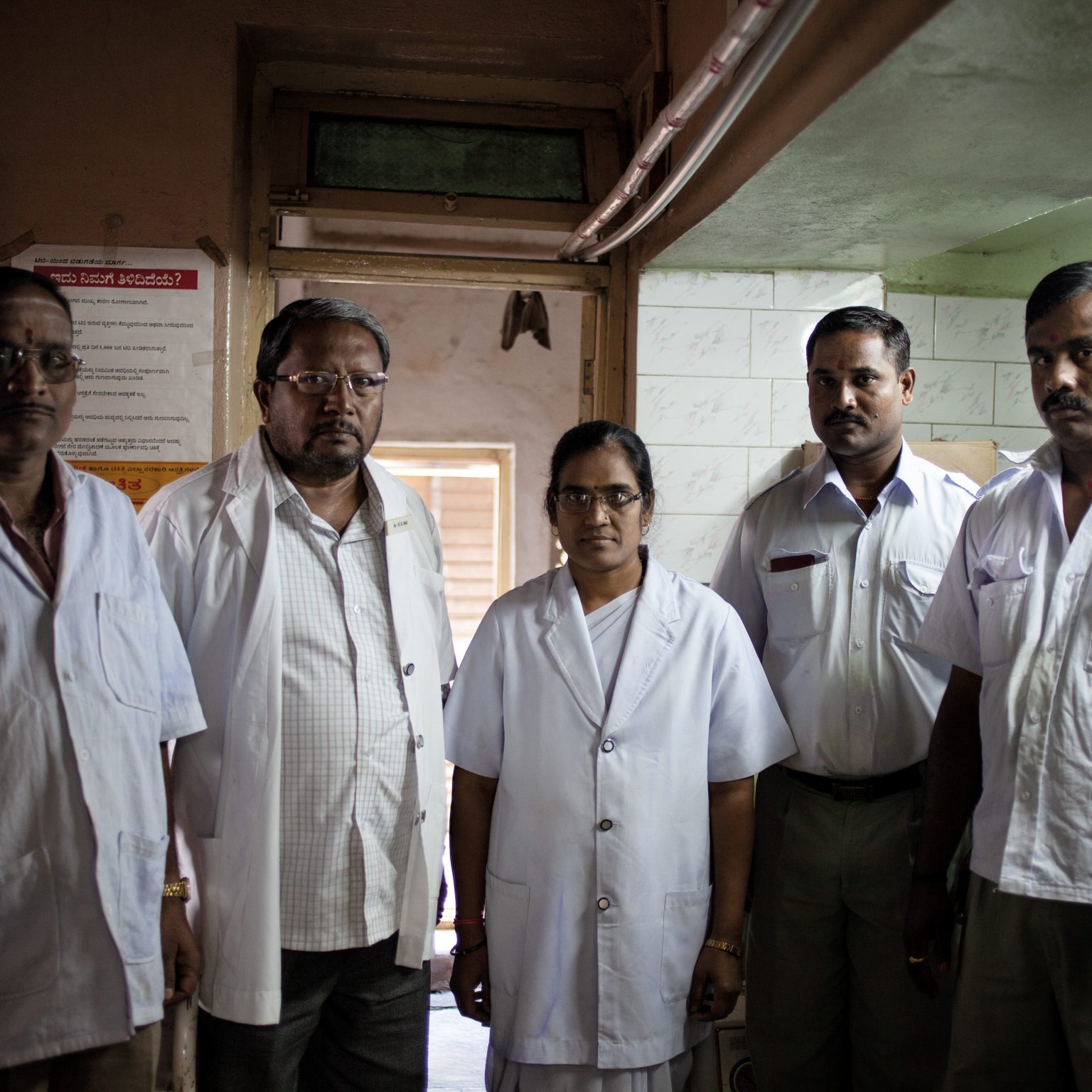Nipani, India. The medical team of the Beedi Workers Welfare Association, in a hospital that takes care of the bidi rollers of the region. The structure is sponsored by the Government of India and the Minister of Labour.  Every day, some 30 to 50 patients require medical assistance. Rates of respiratory and skin infections are high among bidi rollers, and malnutrition is also important because of their low socio-economical status. When sick or at the hospital, bidi rollers are not able to reach their daily production of bidis, hence they don't get paid.