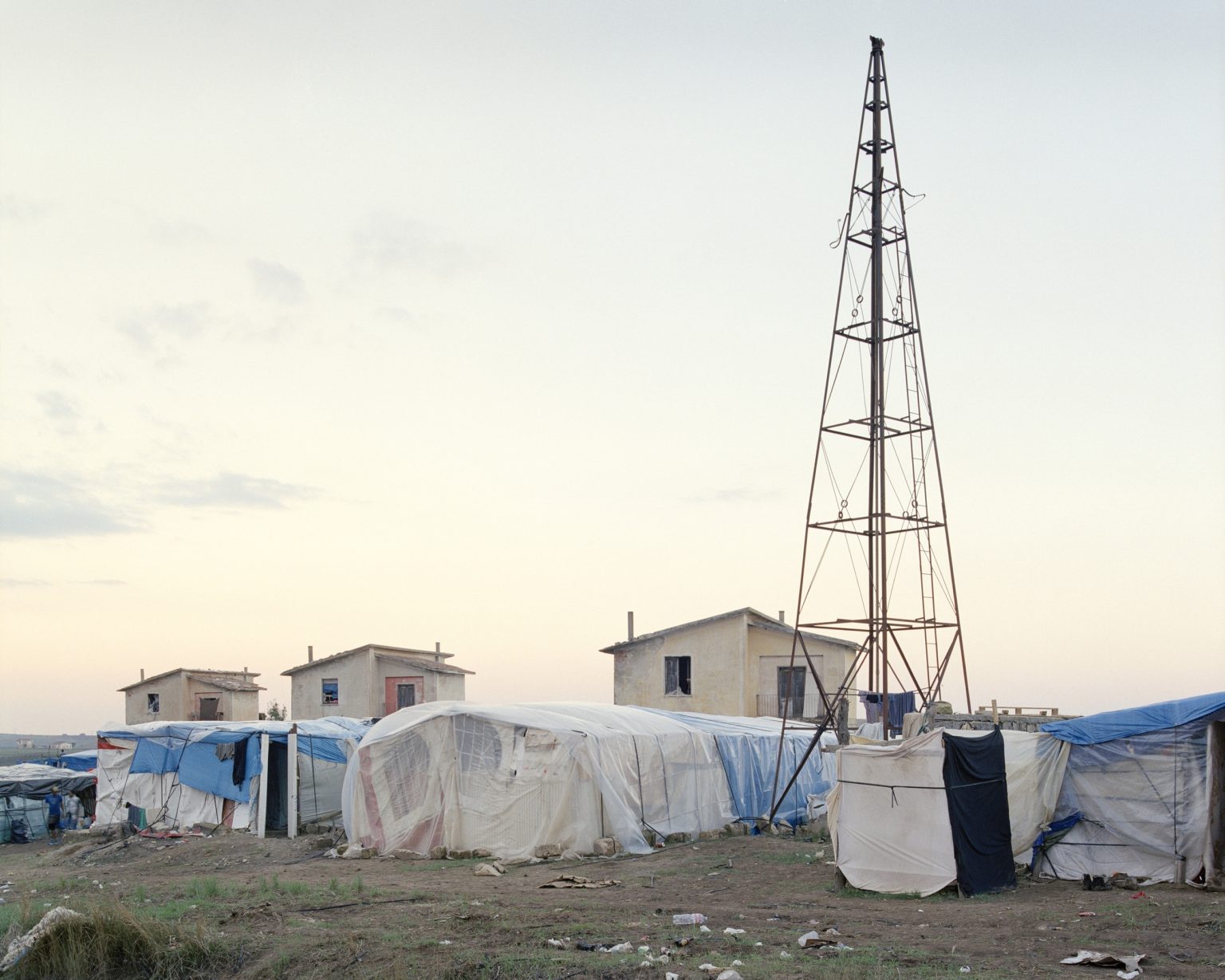 Palazzo San Gervasio (PZ), 2016. Ghetto of Mulini Matinelle, informal camp where about 500 daily laborers live during the season of the tomato harvesting in Basilicata. The ghetto was established by the occupation of some houses of the agrarian reform and soon expanded with temporary shacks without toilets, electricity and running water. ><

Palazzo San Gervasio (PZ), 2016. Ghetto di Mulini Matinelle, campo temporaneo dove vivono circa 500 lavoratori Africani durante la stagione della raccolta dei pomodori in Basilicata. Il ghetto nasce dalloccupazione di alcune case della riforma agraria e in breve tempo si è espanso con baracche temporanee senza servizi igienici, elettricità e acqua corrente.