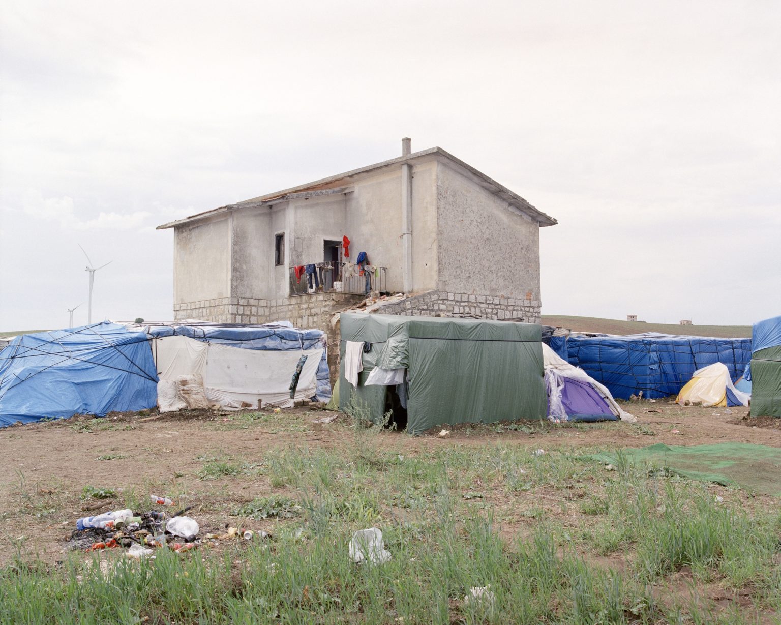 Palazzo San Gervasio (PZ), 2016. Ghetto of Mulini Matinelle, informal camp where about 500 daily laborers live during the season of the tomato harvesting in Basilicata. The ghetto was established by the occupation of some houses of the agrarian reform and soon expanded with temporary shacks without toilets, electricity and running water. ><

Palazzo San Gervasio (PZ), 2016. Ghetto di Mulini Matinelle, campo temporaneo dove vivono circa 500 lavoratori Africani durante la stagione della raccolta dei pomodori in Basilicata. Il ghetto nasce dalloccupazione di alcune case della riforma agraria e in breve tempo si è espanso con baracche temporanee senza servizi igienici, elettricità e acqua corrente.