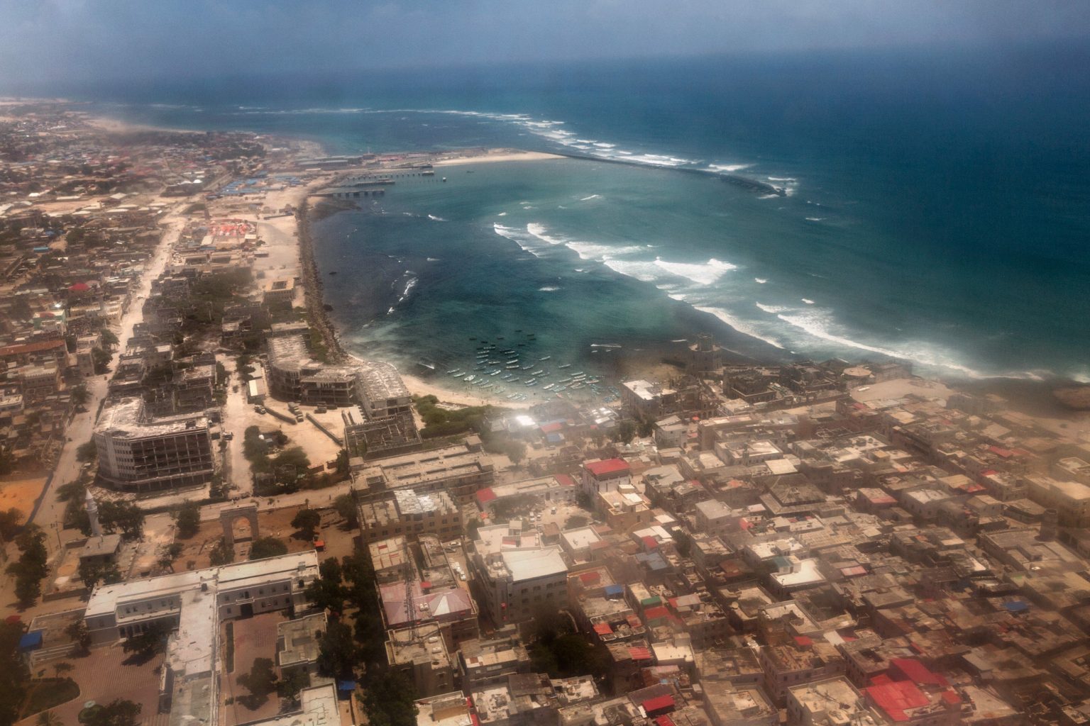 Africa, Somalia, Mogadishu. 16/10/2015. Mogadishu from above. The present of the Somali capital. Behind it, a civil war lasting 25 years; ahead of it, a future of rebirth. Mogadishu is at a crossroads. On the one side, the persistence of a surreptitious conflict based on a new, asymmetrical strategy of terror with Al-Shabaab, yet on the other, a desire for a return to normal life on the part of the Somali people, who are timidly seeking to carve out a role for themselves.