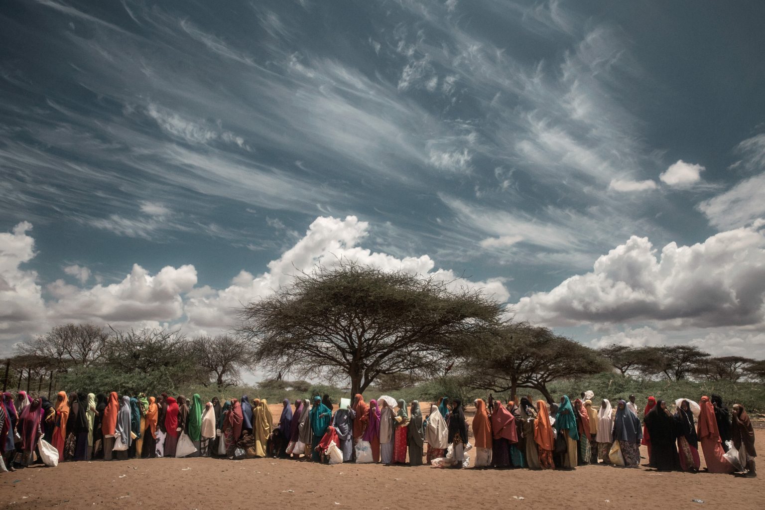Africa, Kenya, Dadaab. 01/03/2016. Dadaab remains the largest refugee camp in the world, with more than 350,000 inhabitants, 95% of them from Somalia. 
Located in a semi-arid region of Kenya, 80 km from the Somali border, the camp arose in the Nineties to contain the displaced fleeing from the civil war in Somalia, and has continued to expand since then. Today it is composed of 5 large tent cities spread over more than 50 km. 

The first week of every month, for five days, food is distributed in Dadaab. All 350,000 refugees report to the distribution points where the WFP distributes food rations. For each member, families are given a monthly ration of 3.5kg of corn, 3kg of flour, 1.8kg of pulses, 1.85lt of oil, 1kg of CSB (Corn-Soya Blend) and 150g of salt.