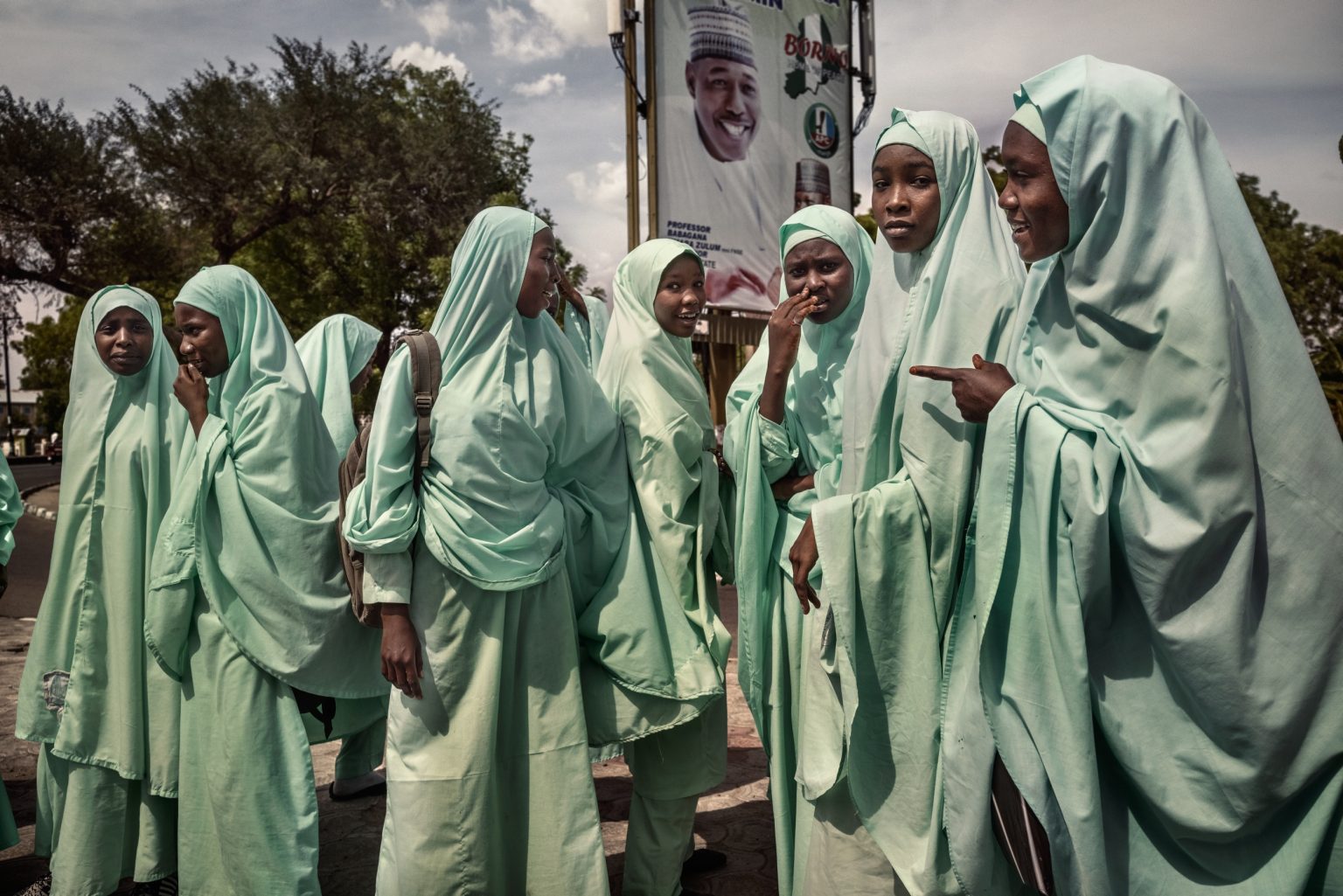 Maiduguri, Nigeria, Africa, May 2021 - Some female students are gathiering afte school. Designated as a terrorist group in the United States in 2013, Boko Haram gained international importance in April 2014, when its militants kidnapped 276 schoolgirls from their dorms in Chibok, a mainly Christian town located about 80 miles from Maiduguri, capital city of Borno State.
Despite on the 20 of May Abubakar Shekau might have killed himself in order not to be caught from the new jihadist secessionist group affiliated with ISIS, called Iswap (Islamic State West Africa Province), Boko Haram keeps on being a threat in the entire Lake Chad area, which includes north-western Nigeria, remaining deadly as always. ><
Maiduguri, Nigeria, Africa, maggio 2021 -  Alcune studentesse si rtorvano dopo scuola. Designato gruppo terroristico dagli Stati Uniti nel 2013, Boko Haram ha guadagnato importanza internazionale nell'aprile 2014, quando i suoi militanti hanno rapito 276 studentesse dai loro dormitori a Chibok, una città prevalentemente cristiana a circa 80 miglia da Maiduguri, la capitale dello stato di Borno. Nonostante il 20 maggio Abubakar Shekau si sarebbe suicidato per non essere catturato dai militanti del nuovo gruppo jihadista secessionista affiliato allIsis,  chiamato Iswap (Islamic State West Africa Province),  Boko Haram rimane una minaccia nell'intera regione del Lago Ciad, che include la Nigeria nordorientale, rimanendo  "letale come sempre.