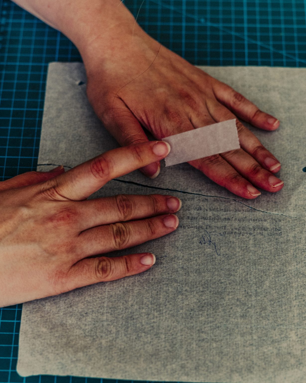 Ruth Zimmermann, an archivist, delicately applies tape to the back of an assembled document in Berlin, July 16, 2021. Researchers are working to reassemble, scrap by scrap, some 40 to 55 million pieces of paper that were torn up and stuffed into sacks by the East German secret police in the final days of the German Democratic Republic. (Mustafah Abdulaziz/The New York Times)     <span style="color: #ff0000">*** SPECIAL   FEE   APPLIES ***</span> *** Local Caption *** 16.15556747