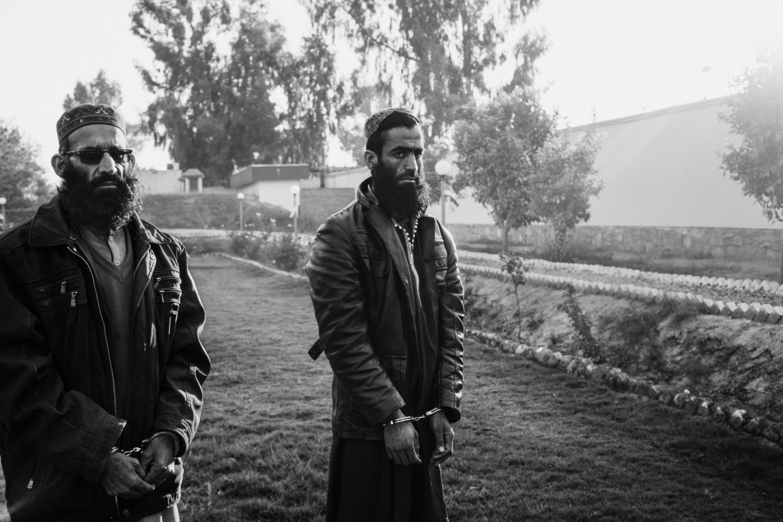 Achin, Afghanistan, November 2019 -  Abdul Mateen (left), 45 year old, originally from Pakistan, was a member of ISIS religious police in Achin. He prevented illegal drug cultivation and made sure everybody prayed five times a day. He was a member of the Pakistani Taliban and came to Afghanistan when the Pakistani army launched an operation in the border areas. He then the pledged allegiance to ISIS together with the other fighters.  Rahmatullah Sufyan (right), 30 years old, is also originally from Pakistan. He was a member of the Pakistani Taliban and came to Afghanistan when the Pakistani army launched an operation in the border areas. He then the pledged allegiance to ISIS together with the other fighters. Rahmatullah was injured in a drone attack and he spent two month bedridden in hospital. They both surrendered to Afghan forces before the fall of ISIS in Achin and now they are in detention. >< 
Achin, Afganistan, novembre 2019 - Abdul Mateen (a sinistra), 45 anni, originario del Pakistan, era un membro della polizia religiosa dellIS, a Achin. Ha vietato la coltivazione di droga e si è assicurato che tutti pregassero cinque volte al giorno. Era anche membro dei talebani Pakistani ed è arrivato in Afganistan quando lesercito pakistano ha lanciato unoperazione nelle aree di confine. Ha poi giurato fedeltà allIsis, insieme agli altri combattenti. Rahmatullah Sufyan (a destra), 30 anni, è anchesso originario del Pakistan. Era un membro dei talebani pakistani quando lesercito pakistano ha lanciato unoperazione nelle aree di confine. Ha poi giurato fedeltà allIsis, insieme agli altri combattenti. Rahmatullah è rimasto ferito nel corso di un attacco di drone e ha trascorso due mesi in un letto di ospedale. Sia Abdul che  Rahmatullah sis ono arresi alle forze afgane prima della caduta dellIsis ad Achin e ora sono in stato detentivo.
