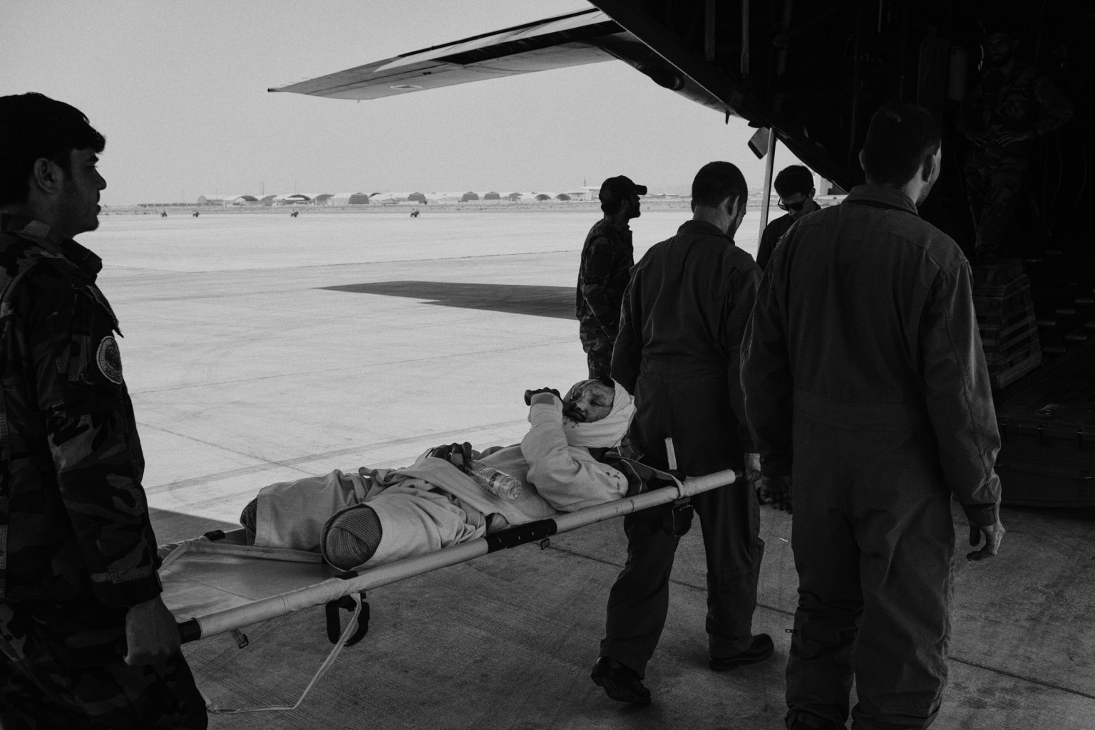 LASHKAR GHA, AFGHANISTAN - MAY 27, 2021:
A member of the Afghan security forces, injured during the fighting, is evacuated on a military flight from Kandahar airfield to Kabul.
After American troops began leaving Afghanistan in early May the Taliban mounted an offensive in the southern city of Lashkar Gha. Afghan security forces were struggling to hold the besieged city.

(Photo by Lorenzo Tugnoli/ Washington Post/ Contrasto)