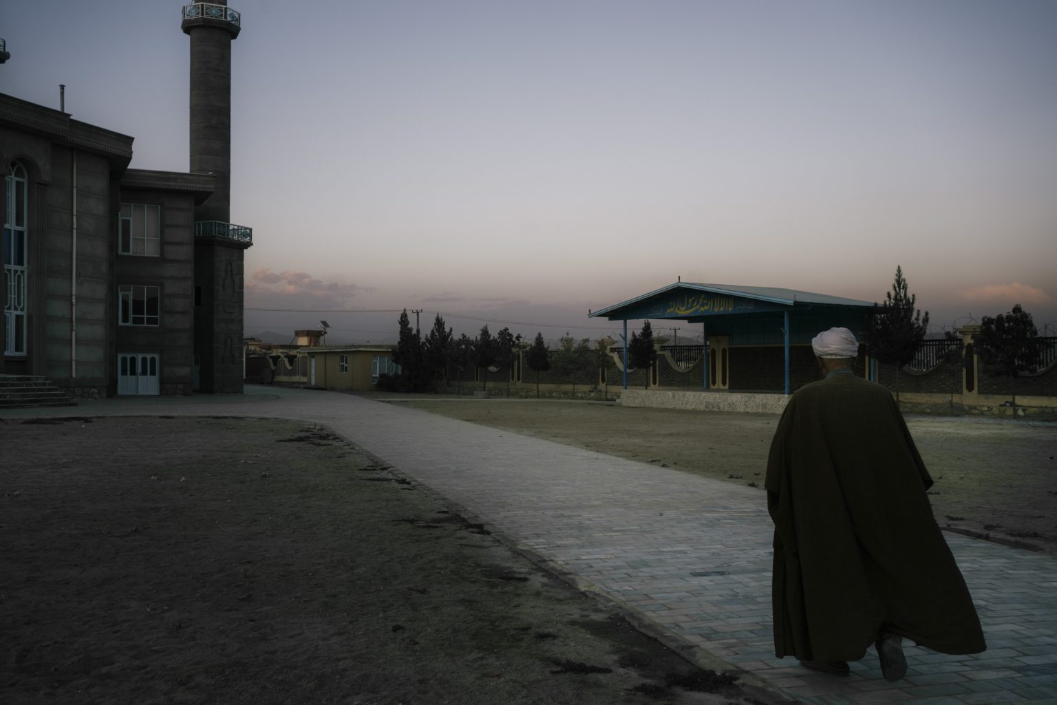 GHAZNI, AFGHANISTAN - OCTOBER 17:
Ibrahim Salehi walks towards the Mohammad Mustafa Mosque, GhazniÕs largest Shiite center of worship. 
(Photo by Lorenzo Tugnoli/ The Washington Post)