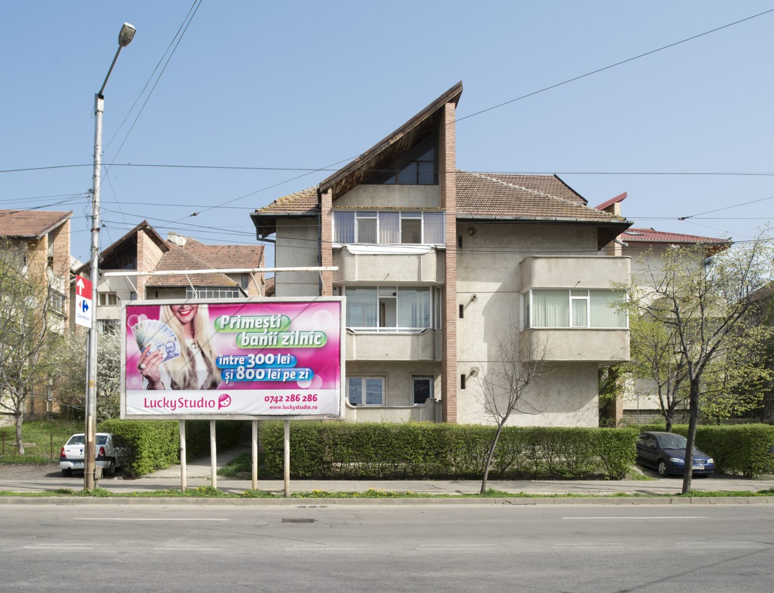 Romania, Ia?i, April 2016: an advertisement billboard in a street of the city promising daily earnings for the cam models between 300 and 800 RON (approx. between 66 and 178 euros).