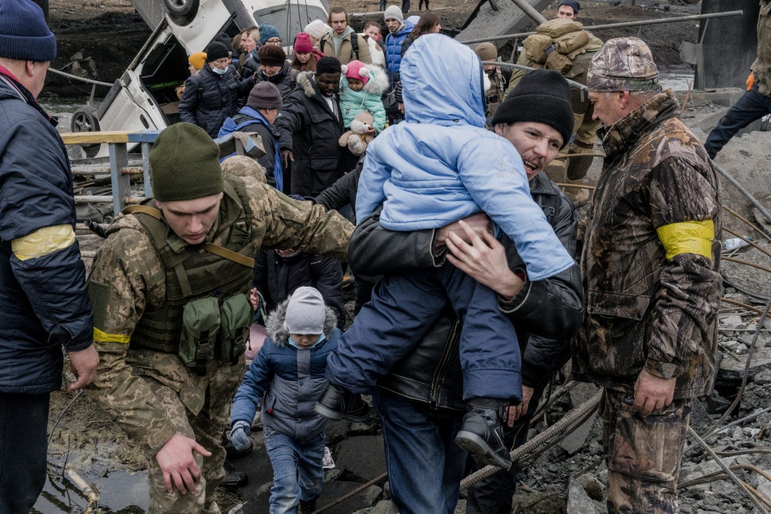 UKRAINE, Kyiv. March 05, 2022 - People cross a destroyed bridge as they try to leave the city of Irpin, in the Kyiv region.