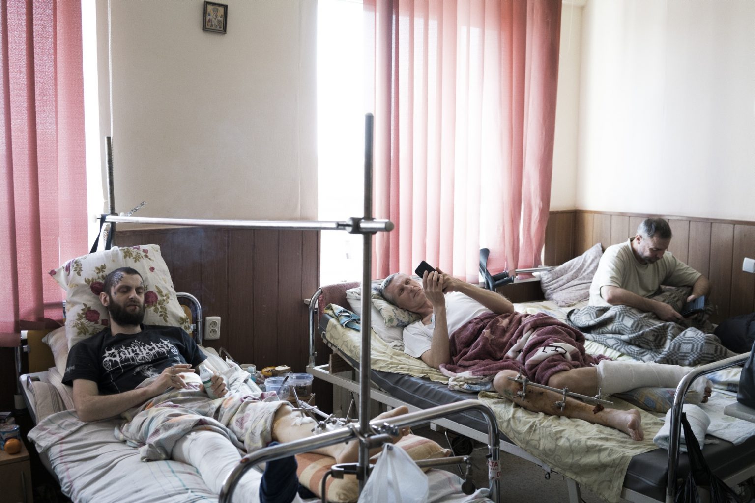 UKRAINE, Kharkiv. March 17, 2022 - Men injured by shelling lie in beds in a hospital in Kharkiv.