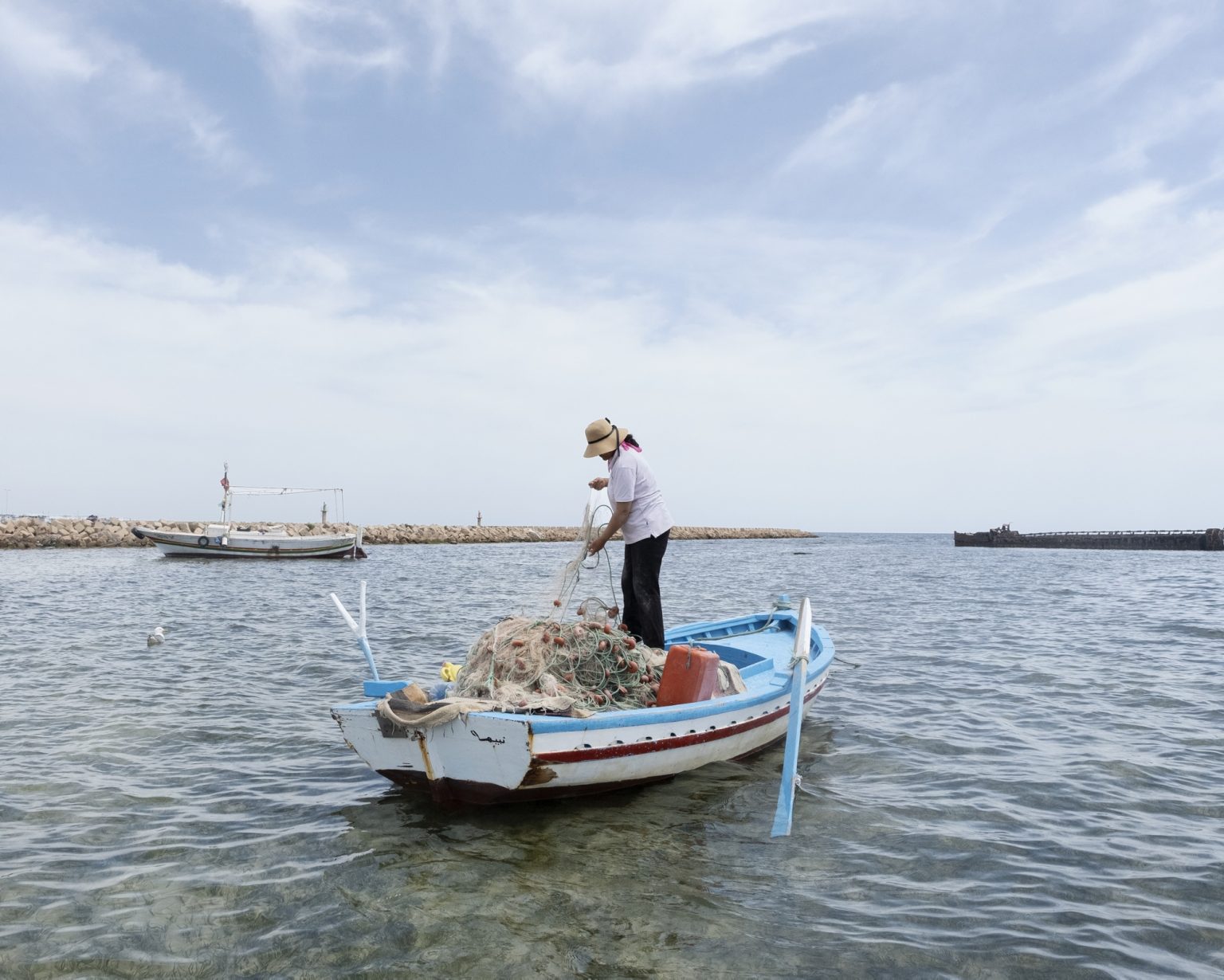 Kerkennah Islands (Tunisia), June 2022 - Sara Souissi is a fisherwoman from the island, she goes out to sea every day with her rowing boat. Her nets are filled almost exclusively with the blue crab, an invasive alien species from the Red Sea, nicknamed 'Daesh' by fishermen because of its devastating impact on the marine ecosystem and on fishing nets that are cut by the power of the claws and the spines around them. Forced to buy back the nets several times a year, Sara is supported by the COSPE Onlus through the FAIRE project for the creation of economic opportunities for the women of the island (alternatives or complementary to fishing in the sea or on foot). She doesn't earn much from the sale of the crab: while shrimp can be sold between 25 and 40 dinars per kg, the blue crab is worth about 2 dinars per kg.
><
Isole Kerkennah (Tunisia), giugno 2022 - Sara Souissi è una pescatrice dellisola, esce in mare tutti i giorni con la sua barca a remi. Le sue reti si riempiono quasi solo del granchio blu, una specie aliena invasiva proveniente dal Mar Rosso, soprannominata dai pescatori Daesh a causa del suo impatto devastante sullecosistema marino e sulle reti da pesca che vengono tagliate dalle potenza delle chele e dalle spine presenti attorno ad esse. Costretta a ricomprare le reti più volte lanno, Sara è sostenuta dalla Onlus COSPE attraverso il progetto FAIRE per la creazione di opportunità economiche per le donne dellisola (alternative o complementari alla pesca in mare o a piedi). Dalla vendita del granchio non ottiene molto: mentre i gamberi possono essere venduti tra i 25 e i 40 dinari al kg, il granchio blu vale circa 2 dinari al kg.
