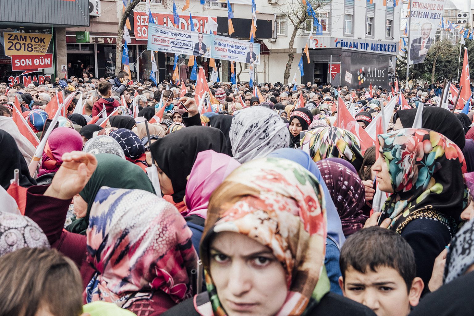 TURKEY. Istanbul, March 2019 – Woman wearing headscarves at a public election campaign rally. Since taking office, Erdogan has encouraged the relaxation of rules against headscarves, which were formerly outlawed as being non-secular, prompting critics to accuse the president of promoting a religious agenda.TURCHIA. Istanbul, March 2019 – Donne a un comizio elettore attendono l'arrivo del presidente Erdogan.