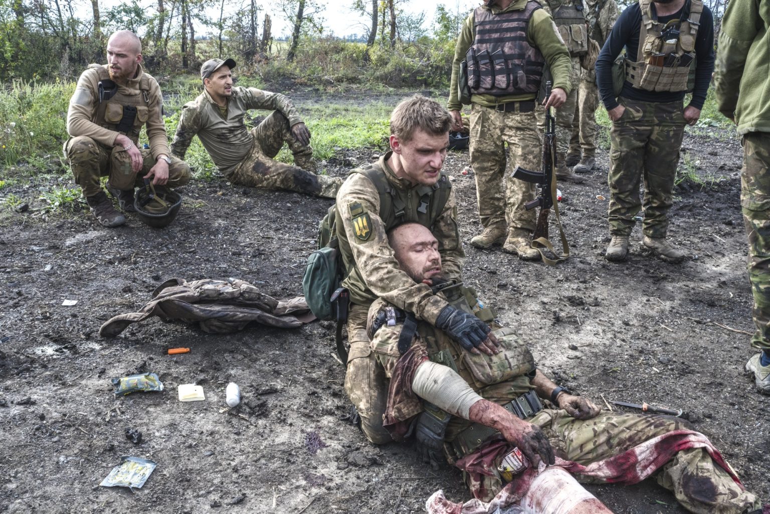 UKRAINE, Sulyhivka village.  September 17, 2022 - Biliy, an Ukrainian serviceman, comforts his comrade, Kostyantyn Rusanov, nom de guerre Nemo, after he received serious injuries from the blast of an anti-personnel mine, south of Sulyhivka village.