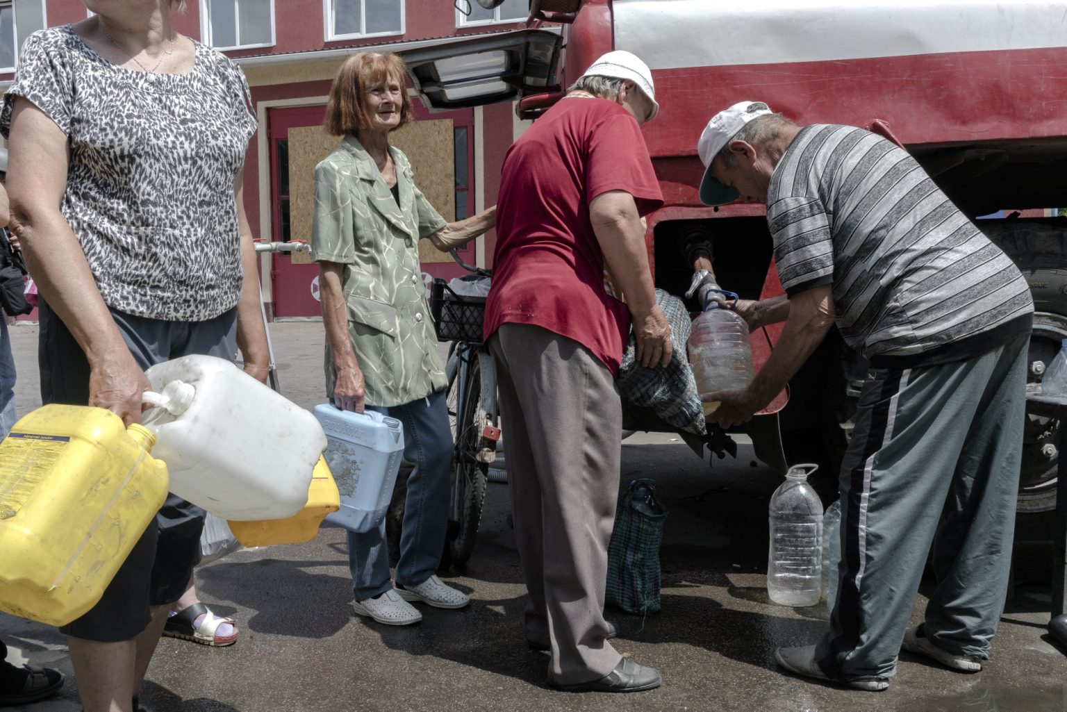 UKRAINE, Lysychansk. June 14, 2022 - People wait in line in the courtyard of the fire station of Lysychansk during water distribution.
