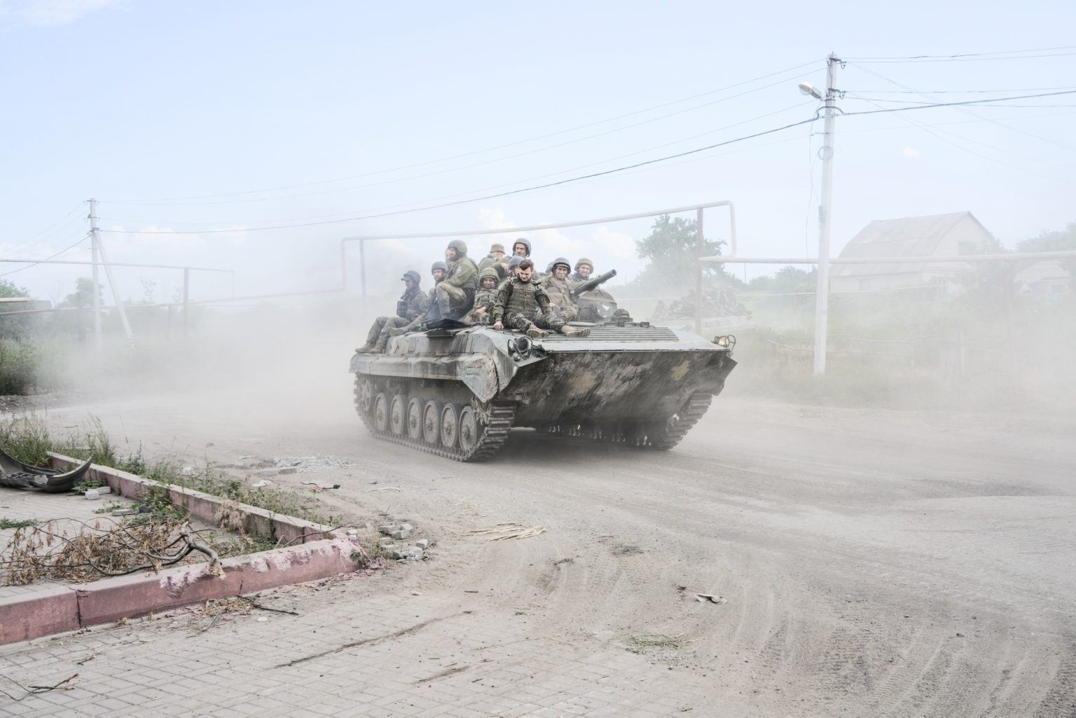 UKRAINE, Donetsk Oblast. June 23, 2022 - Ukrainian servicemen stand on top of an armored vehicle on the road out form Lysychansk to Bakhmut, while fighting raged in the city of Sievierodonetsk.
